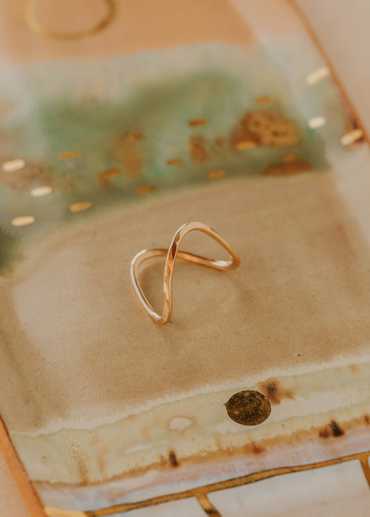 Gold ring on a textured ceramic surface