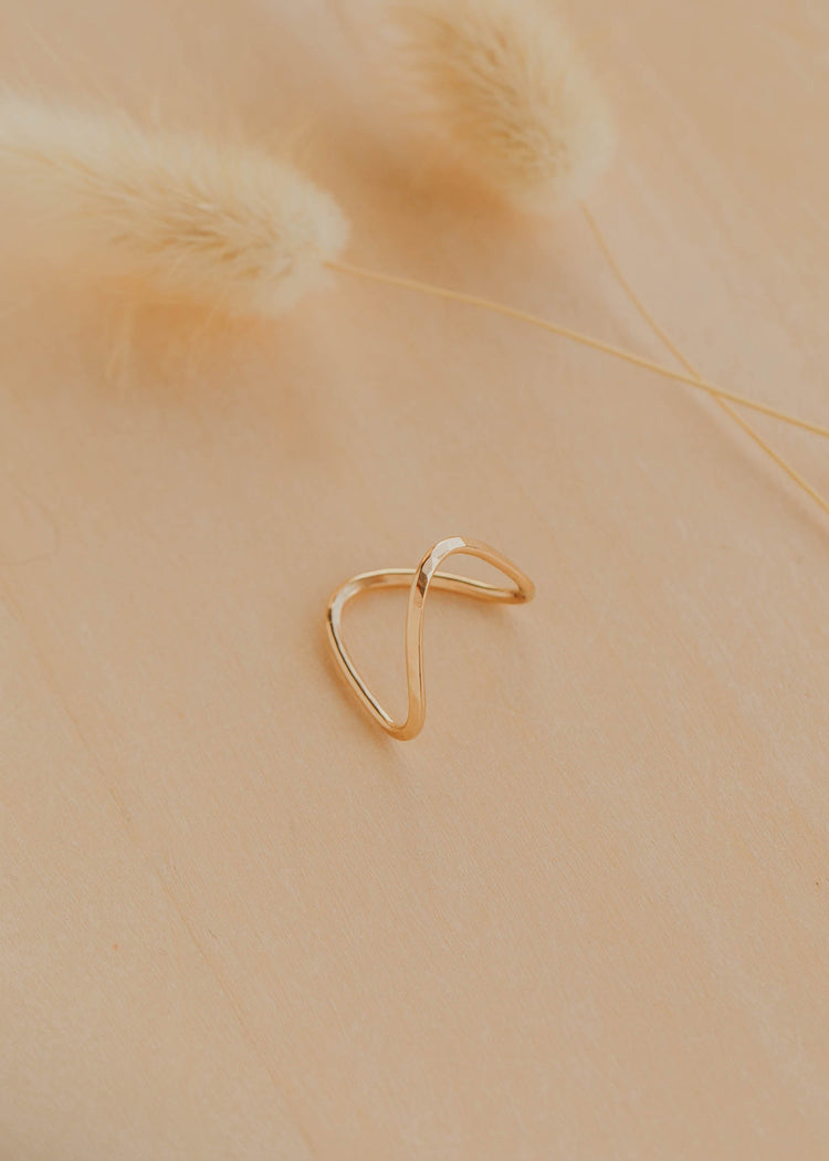 Gold ring on a beige background
