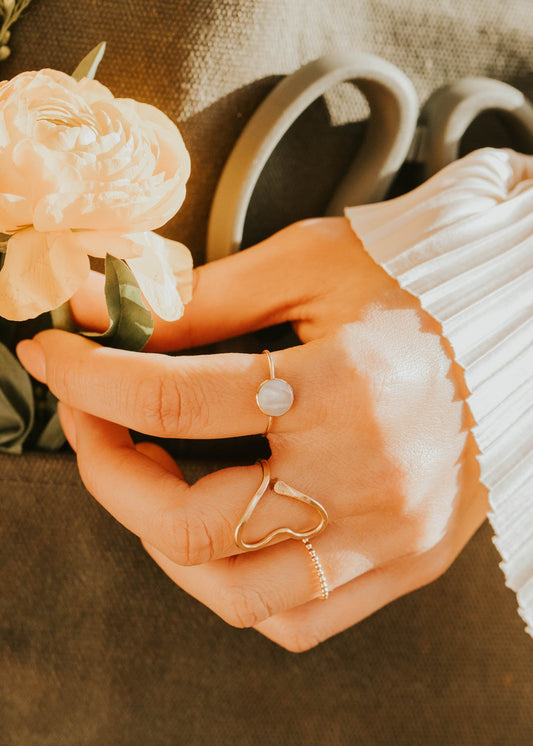 Close-up of hands holding a flower with a blurred background