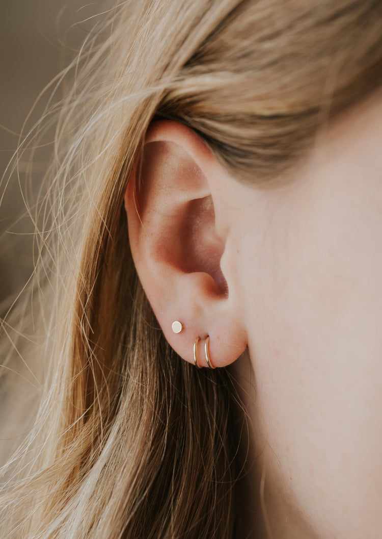 Double hoop earrings for single piercing by Hello Adorn shown on a model styled with circle earrings in 14k gold fill.