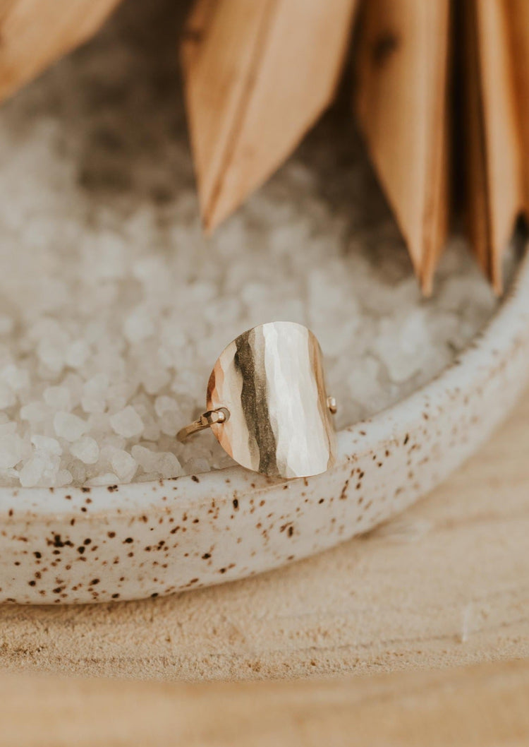 A gold hammered ring created by Hello Adorn in supermoon style to look like a moon ring, a great statement ring to add to your ring stack.