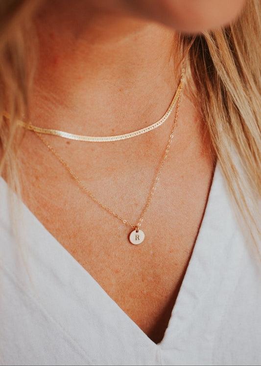 Gold initial necklace by Hello Adorn styled with herra layering chain.