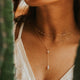 Woman wearing a white lace dress with a blurred natural background
