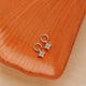 Sterling Silver Grace Charms by Hello Adorn - pair of CZ star charms on small silver huggies on ceramic dish