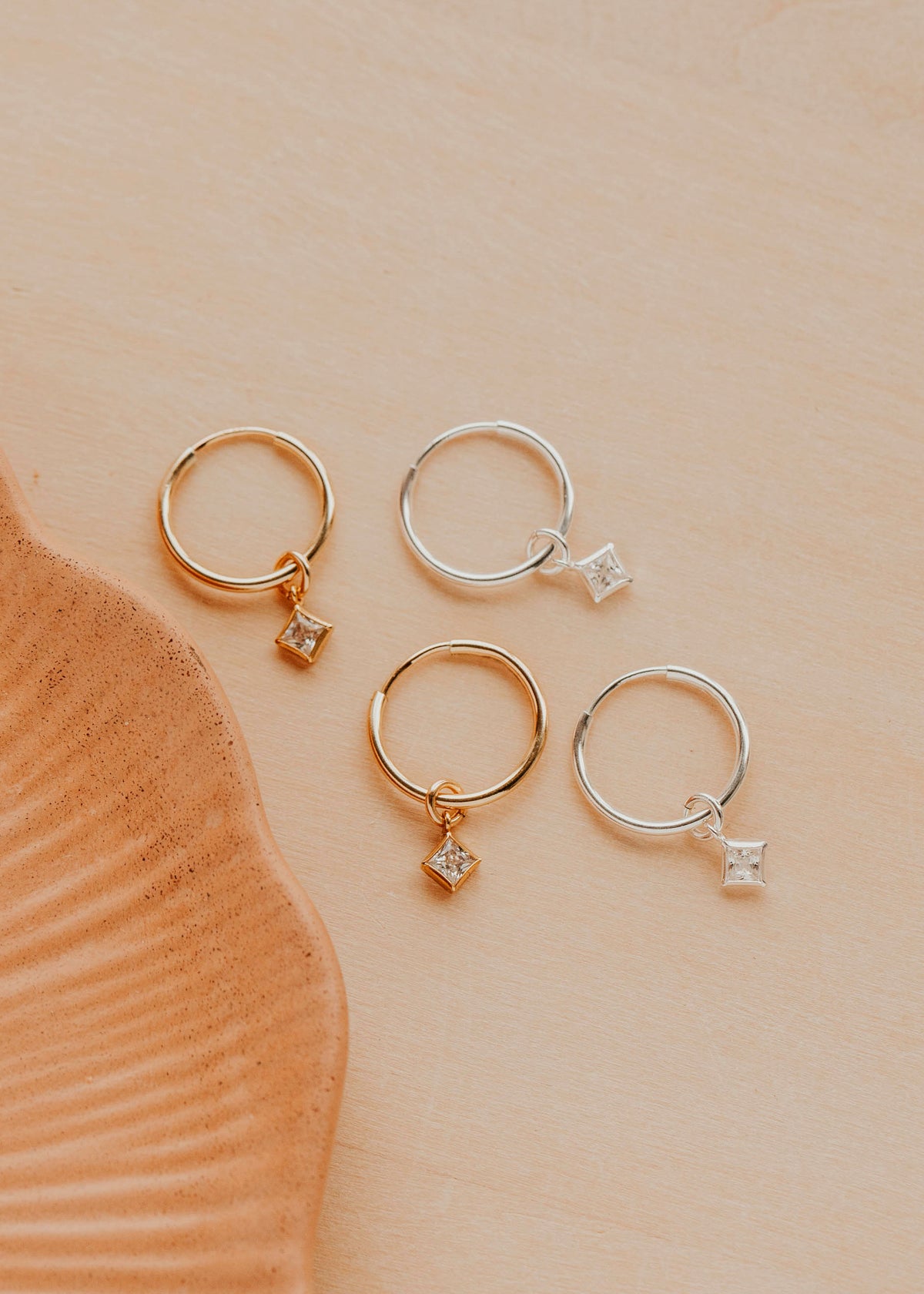 14K Gold Fill and Sterling Silver Grace Hoops by Hello Adorn - both metal options with CZ charms displayed