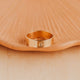 14K Gold Fill Bold Initial Band by Hello Adorn - single wide gold band engraved with letter B on ceramic dish