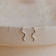 Sterling silver Tiny Wave Ear Climber earrings by Hello Adorn on a ceramic dish