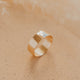 Gold ring on a soft beige background