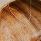 Necklace with a pendant on a wooden dish