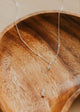 Necklace with a pendant on a wooden dish