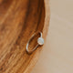 Silver ring on a wooden surface
