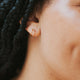 Spiral hoop twist double earrings shown in 14k gold fill on a model by Hello Adorn.