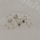Collection of silver earrings on a branded card