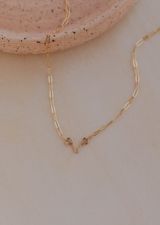 Gold necklace on a neutral background