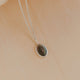 Necklace with a pendant on a beige background