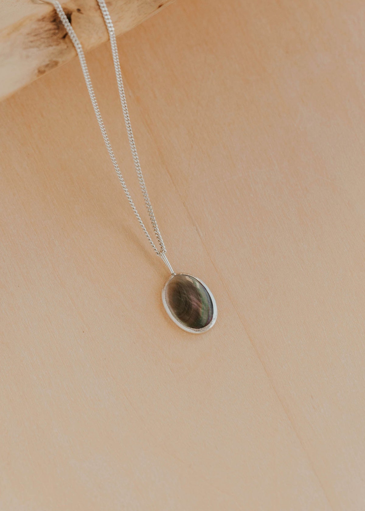 Necklace with a pendant on a beige background