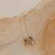 Silver earrings with small beads on a wooden surface