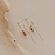Set of gold earrings on a wooden surface