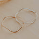 Gold and silver bracelets on a beige surface