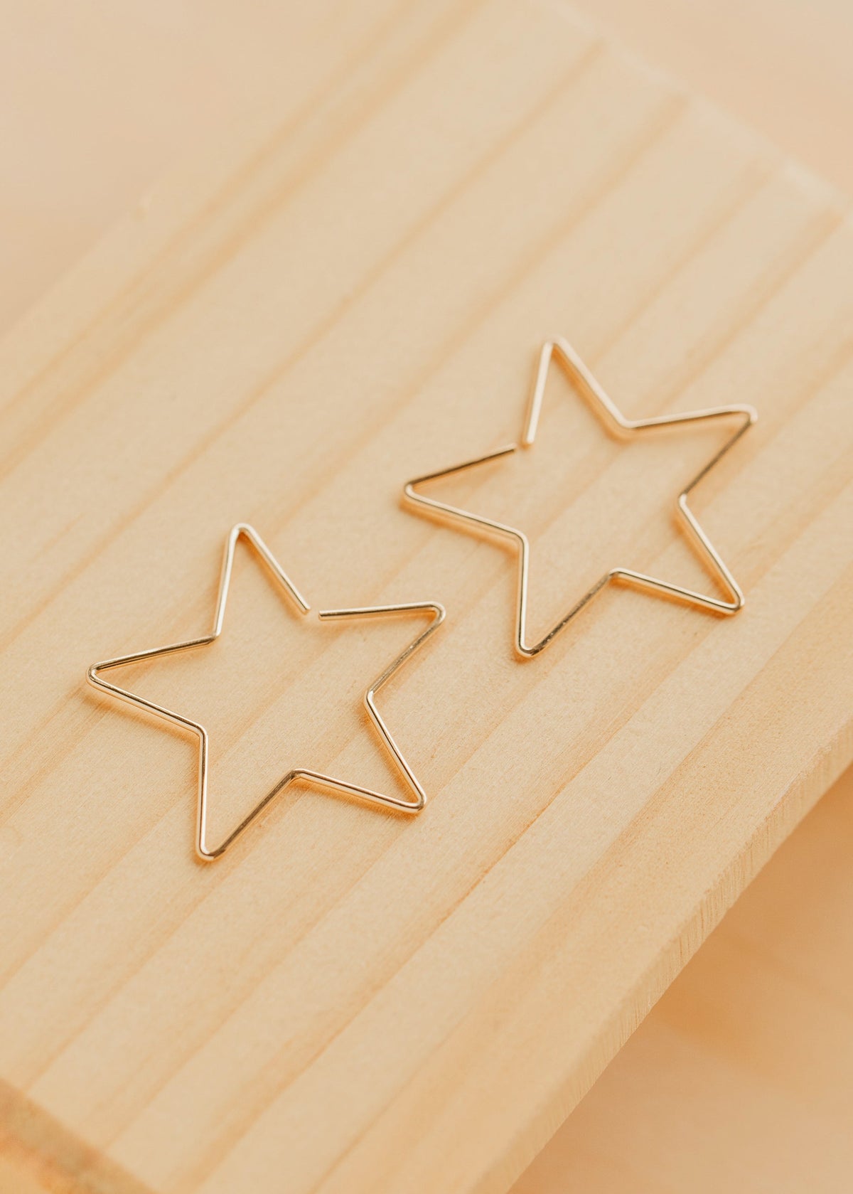 Hello Adorn Star Threader Earrings in 14kt Gold Fill shown flat with a polished background.