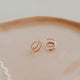 Close-up of tiny twist earrings
