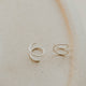 Close-up of tiny twist earrings