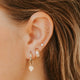 14k gold fill Tiny Wave Ear Climber earring in cartilage styled with opal stud, double gold hoops and kite charm drop by Hello Adorn