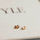 Gold earring backs laying flat by Hello Adorn.