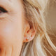 Quartz jewelry shown by Hello Adorn in herkimer diamond earrings styled with gold ball stud earrings in 14k gold fill.