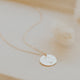 A 14kt Gold Fill round disc hand-stamped with a feminine silhouette drawing promoting body positivity.