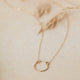 the Full Circle Necklace from Hello Adorn, a necklace of circles attached to a dainty gold chain, a perfect statement necklace.