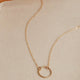 A necklace of circles with a circle pendant attached to a simple gold chain necklace handmade from Hello Adorn in the Full Circle Necklace design.