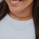 A three layer necklace look paired with a pair of gold hoop earrings, the necklace stack features a thick gold chain choker, a thin layered gold chain, and the Maeve Chain which is a linked chain necklace handmade by Hello Adorn.