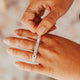 How to use a ring sizer by Hello Adorn shown with a ring stack of squiggle ring, teeny-tiny band, tiny hammered ring, and dani chain ring.
