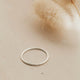 Teeny-Tiny Band by Hello Adorn as a silver stacking ring.