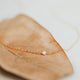 A freshwater pearl necklace created by Hello Adorn as a delicate necklace in the Tiny Freshwater Pearl Necklace style.
