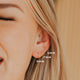 Small gold hoop earring being shown on model in three sizes in 5MM, 7MM, and 9MM styled with confetti chain by Hello Adorn.