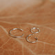 Sterling silver hoop earring shown in three sizes of 5MM, 7MM, and 9MM by Hello Adorn.
