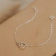 A sterling silver dainty bracelet in Tiny Links Bracelet by Hello Adorn, an interlocking circle necklace to add to any bracelet stack idea.