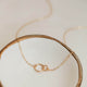 14k gold fill interlocking circle necklace by Hello Adorn laying flat in a jewelry tray.